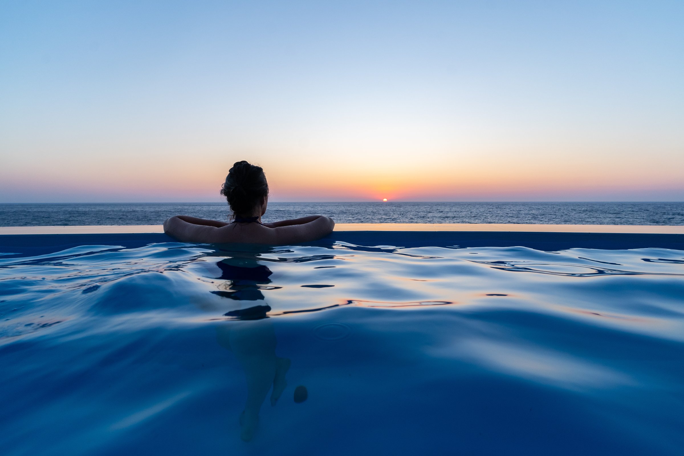 A quiet sunset moment in the infinity pool overlooking the Aegean